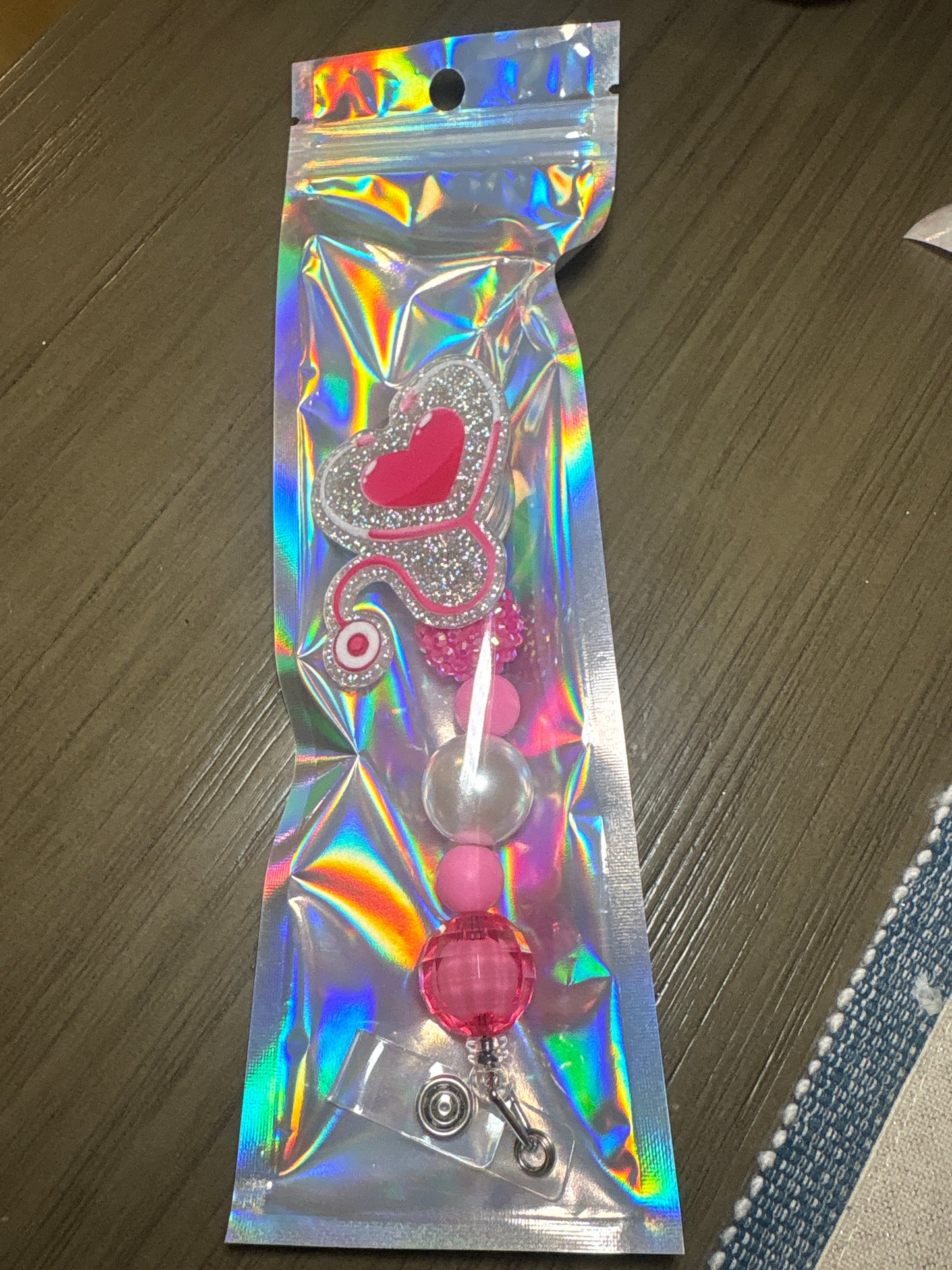 Stethoscope with pink heart badge reel